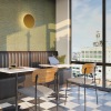 a workroom with tables and chairs and a large window with a view of a city