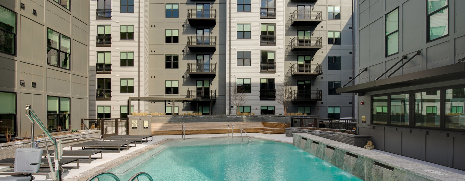 Pool area with sundeck and pool chairs